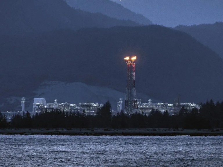 Don’t complain, get paid: Kitimat resident offered thousands from LNG Canada | iNFOnews.ca A flame on a tower at a LNG facility on the ocean.