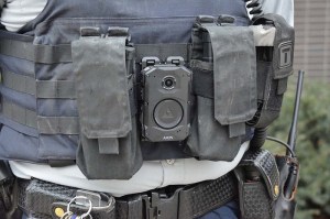 A close-up of a police officer's chest with a body camera.