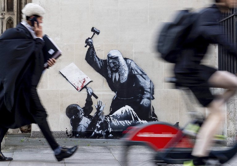 Banksy mural of a judge beating a protester is scrubbed from London court | iNFOnews.ca