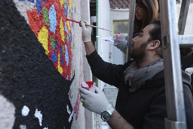 Evacuated Afghan artists paint a mural in Albania's capital | iNFOnews.ca
