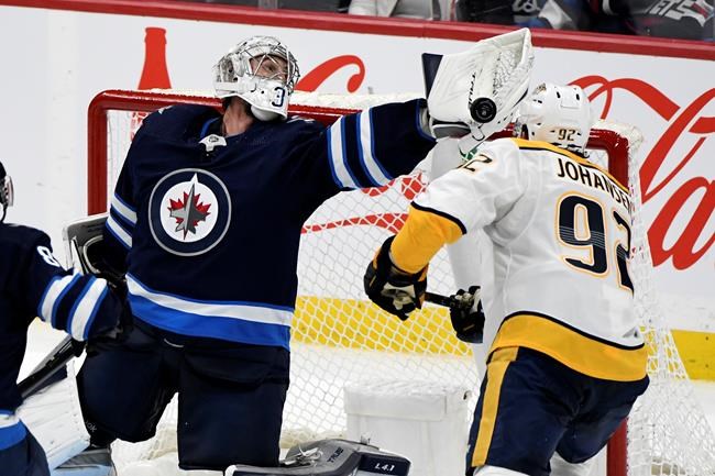 'A little overkill': Jets goalie Connor Hellebuyck not keen on NHL's schedule pause | iNFOnews.ca CP203558587