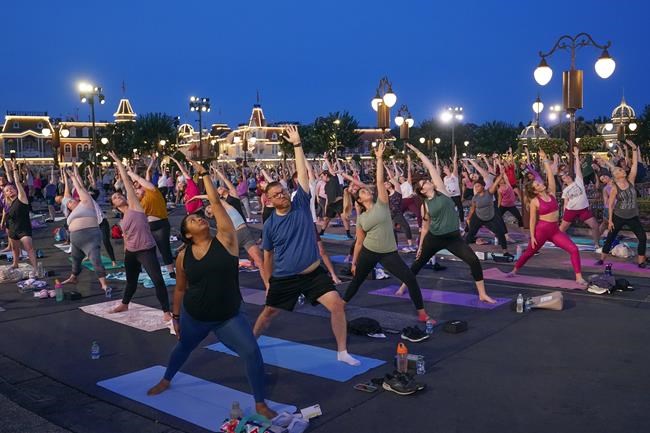 Disney workers trade costumes for yoga pants on Yoga Day | iNFOnews.ca