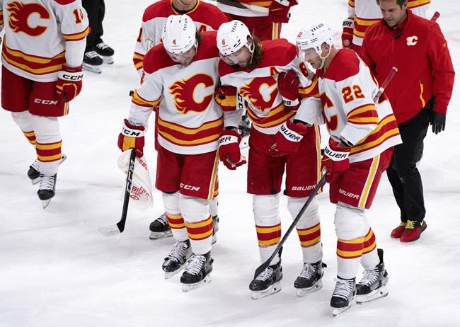 Flames defenceman Chris Tanev leaves game after taking shot to head | iNFOnews.ca