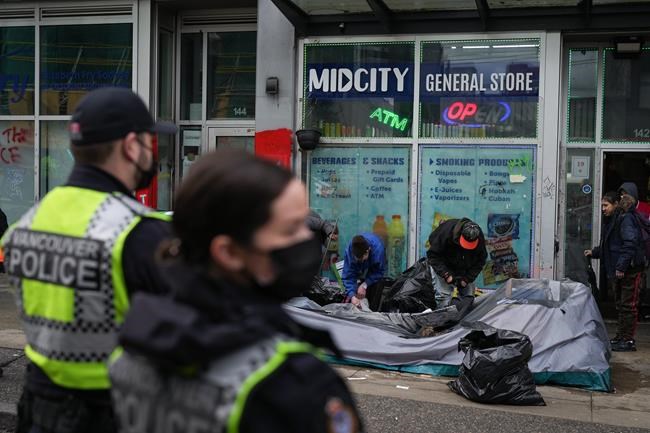 Tents and suitcases go into garbage compactors as Vancouver encampment is dismantled | iNFOnews.ca CP402750060