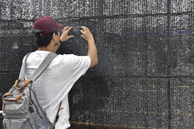 The screen set up to block tourist snapshots of Mount Fuji has several holes in it | iNFOnews.ca The screen set up to block tourist snapshots of Mount Fuji has several holes in it | iNFOnews.ca