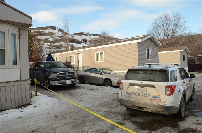 Trailers and a police car taped off as a crime scene.