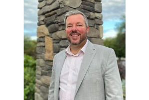 A man in a suit jacket and dress shirt.