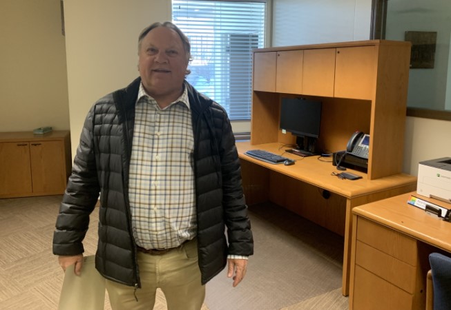 A man stands in an office.