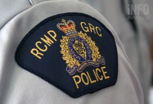 A close-up of an RCMP shoulder patch on a white uniform.