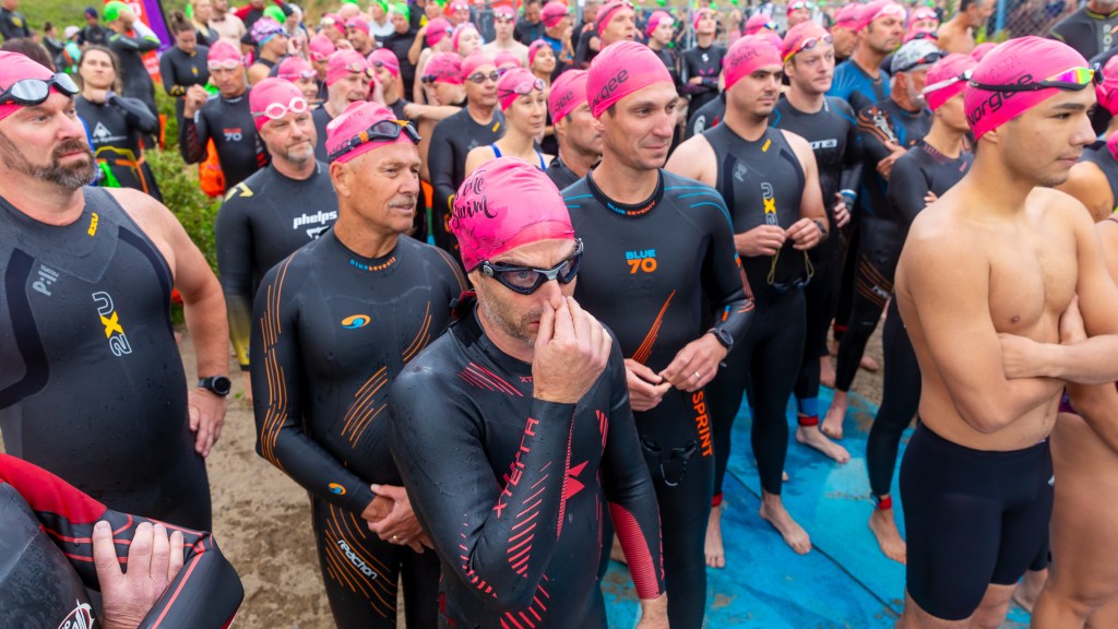 Swimmers prepare to cross Okanagan Lake in longstanding Kelowna tradition | iNFOnews.ca Group of swimmers waiting to start the Across the Lake Swim in Kelowna summer 2025