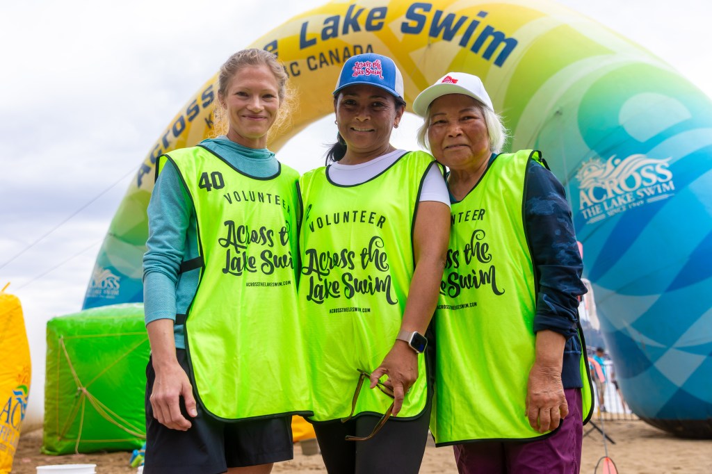 Swimmers prepare to cross Okanagan Lake in longstanding Kelowna tradition | iNFOnews.ca Group of volunteers at the 2025 Kelowna Across the Lake Swim