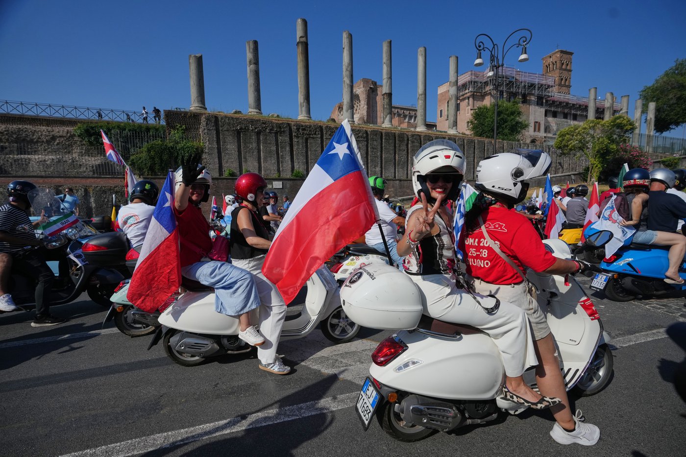 Photos show Vespa enthusiasts buzzing through Rome celebrating the little scooter's 80th anniversary | iNFOnews.ca