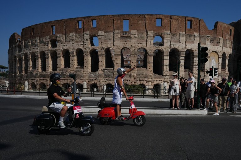 Photos show Vespa enthusiasts buzzing through Rome celebrating the little scooter's 80th anniversary | iNFOnews.ca