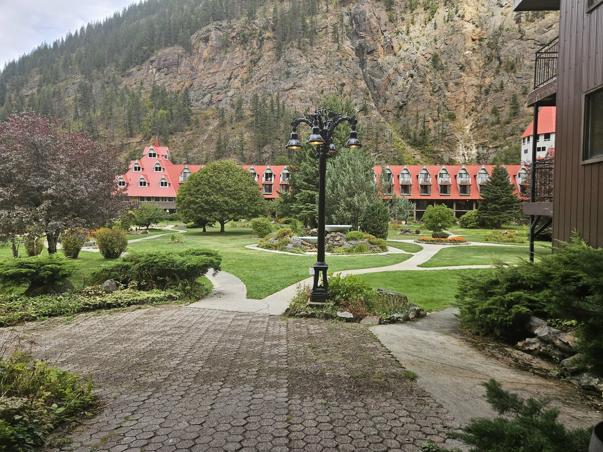 A courtyard has a hotel visible in the background.
