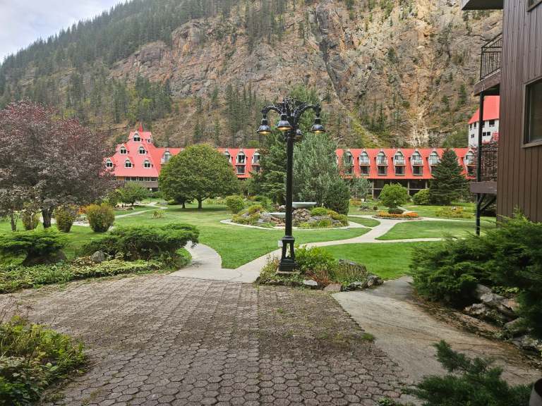 A courtyard has a hotel visible in the background.