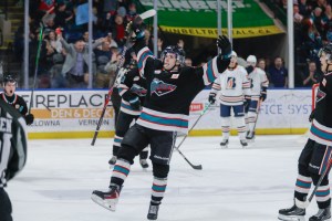 A hockey player celebrates a goal.
