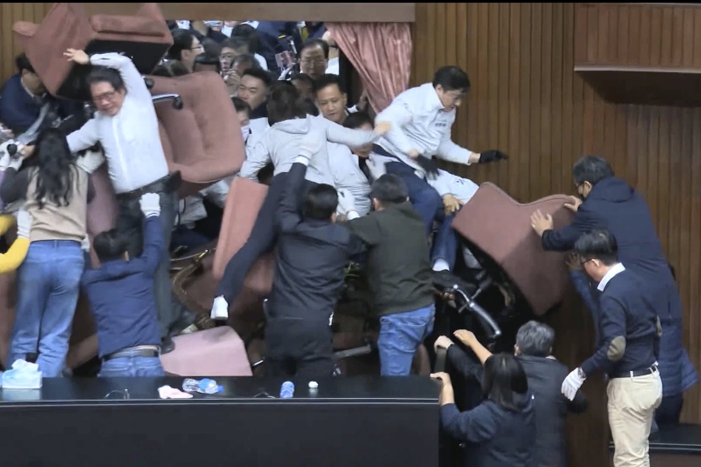 Taiwan lawmakers clash after one party breaks into legislature to occupy speaker's chair | iNFOnews.ca