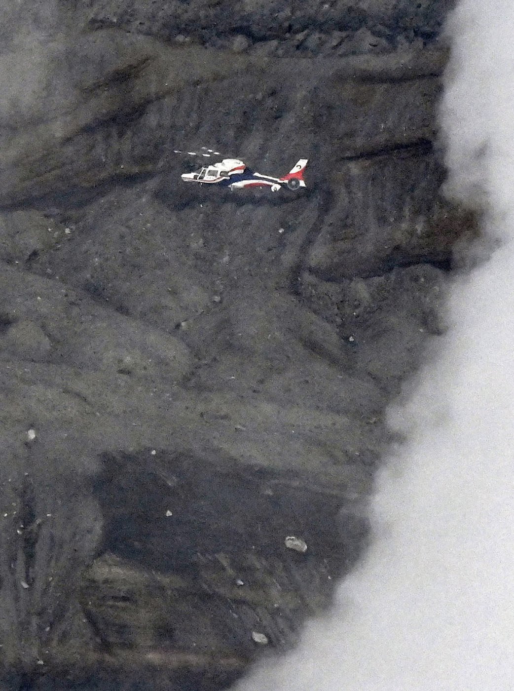 Rescuers spot wreckage possibly from a helicopter that went missing near a volcano in Japan | iNFOnews.ca