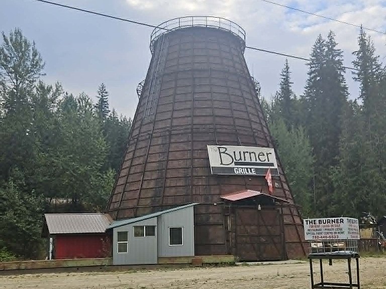 A beehive burner converted to a restaurant has a for sale sign on it.