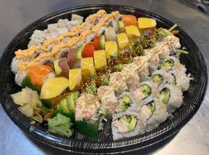 A bowl is filled with rows of different kinds of sushi.