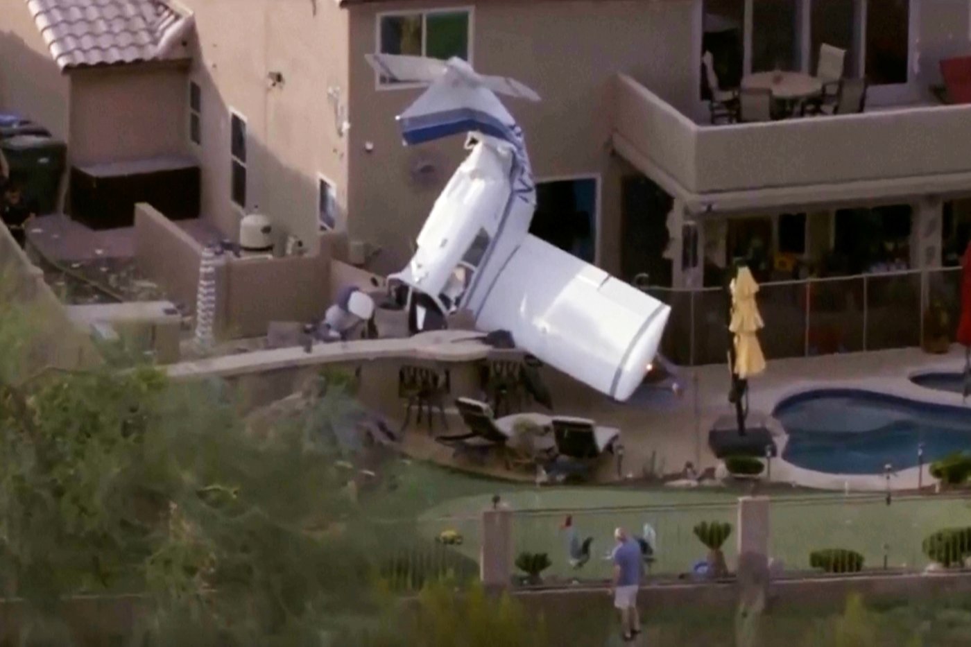 Small plane strikes homes in Phoenix and crashes nose-down next to backyard pool, injuring 3 | iNFOnews.ca