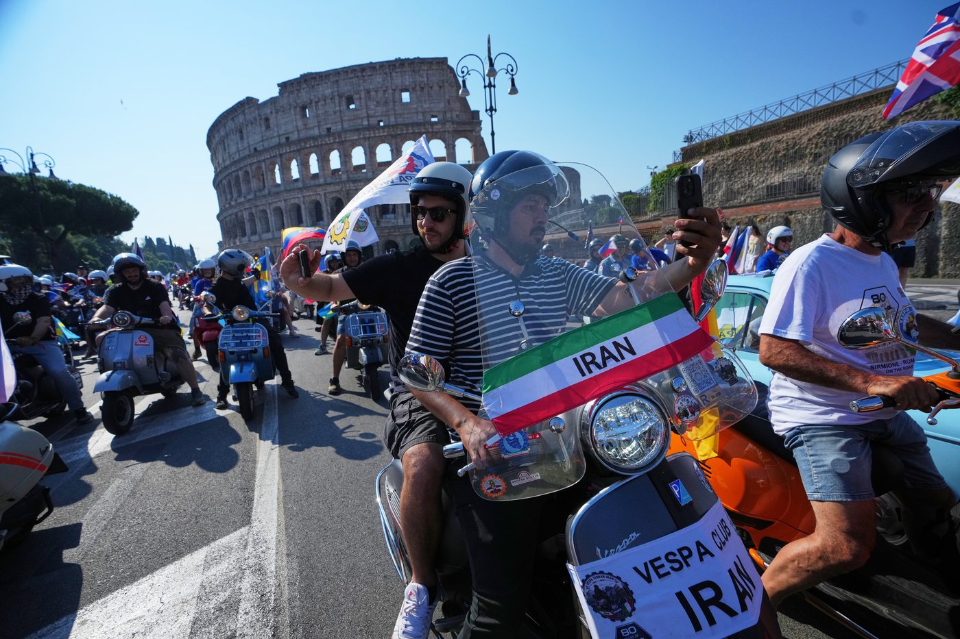 Photos show Vespa enthusiasts buzzing through Rome celebrating the little scooter's 80th anniversary | iNFOnews.ca