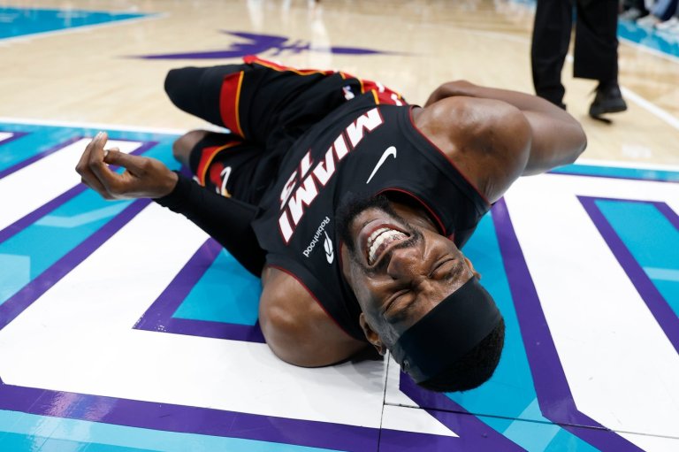 Heat's Bam Adebayo taken to locker room after Hornets' LaMelo Ball trips him, leading to hard fall | iNFOnews.ca