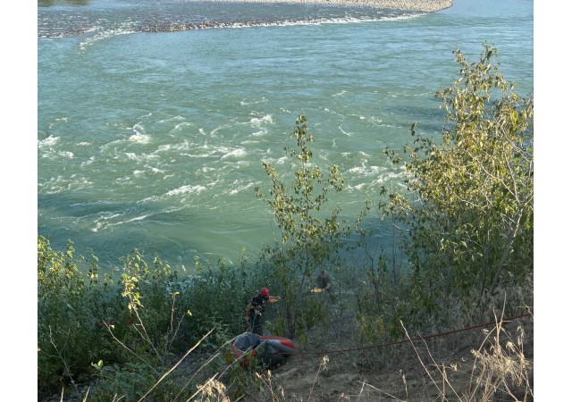 Rope rescue along a riverbank.
