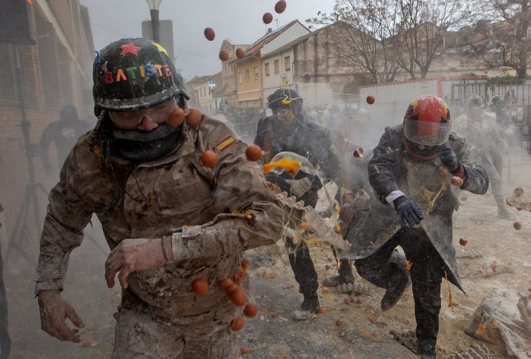 Photos show flour, eggs and firecrackers flying at Spain's Els Enfarinats festival | iNFOnews.ca