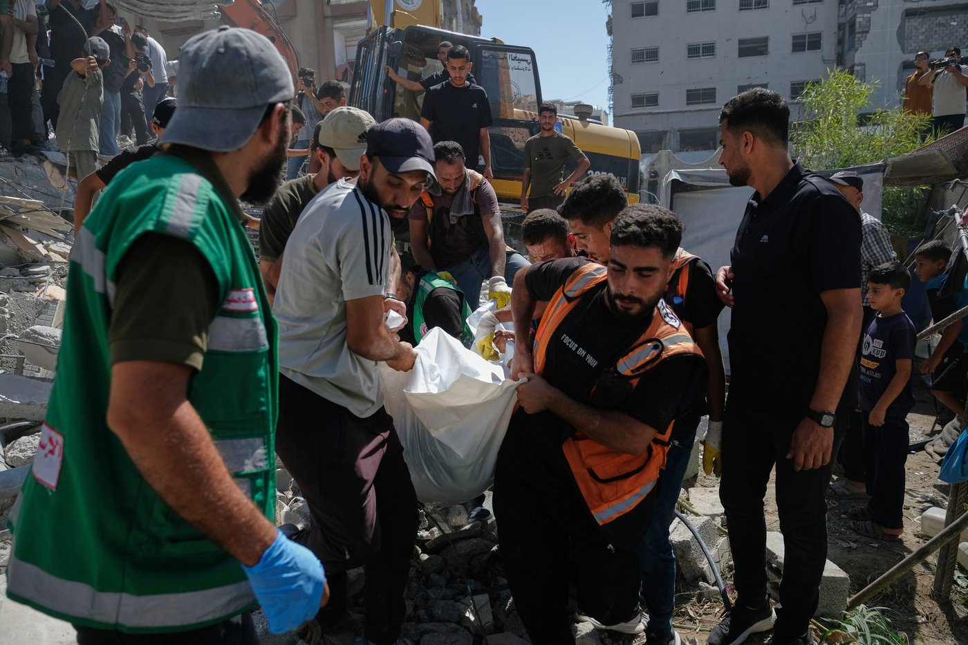 Photos show rescuers recovering bodies after strike-damaged building collapses in Gaza | iNFOnews.ca