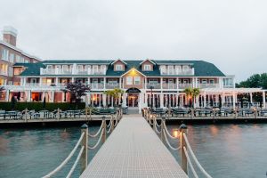 A hotel on the waterfront with a large deck and dock.