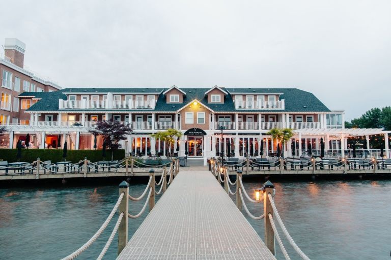 A hotel on the waterfront with a large deck and dock.