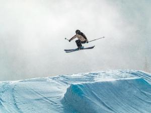 A skier making a jump at a ski resort.