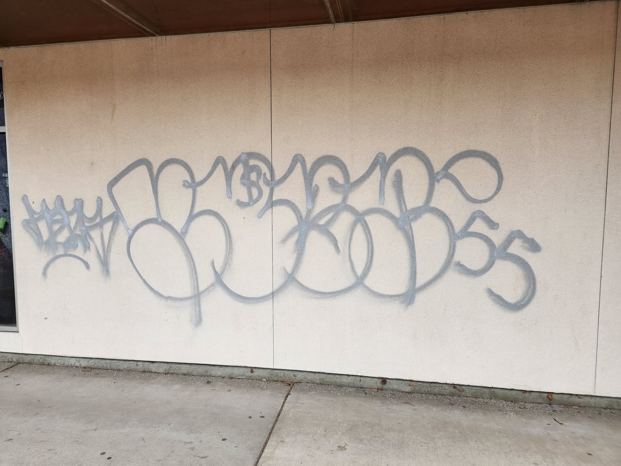 A grey tag on a building.