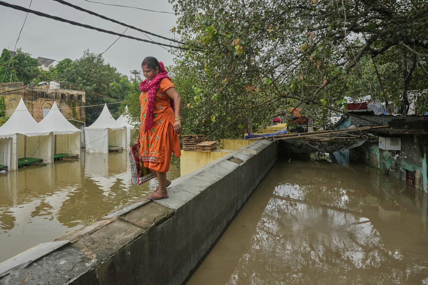 Photos show how one New Delhi family is coping after being displaced twice by floods | iNFOnews.ca