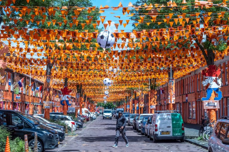 A street in The Hague is drenched in orange as Netherlands soccer fans celebrate the World Cup | iNFOnews.ca