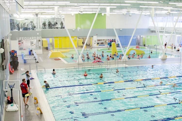 People swimming in a pubic pool.