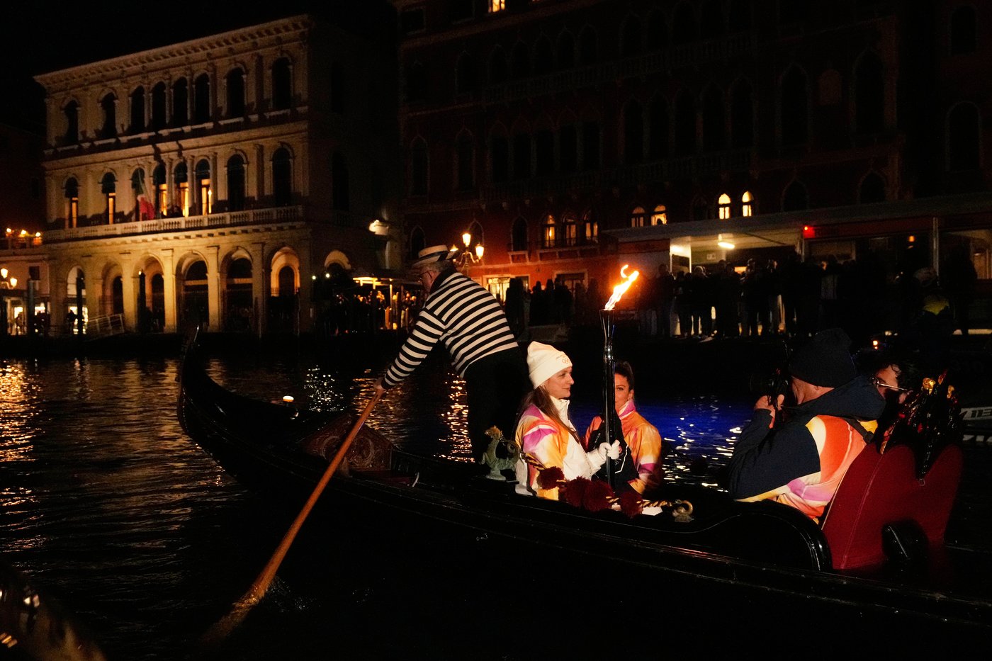 Olympic flame glides on traditional Venetian boats down the Grand Canal | iNFOnews.ca