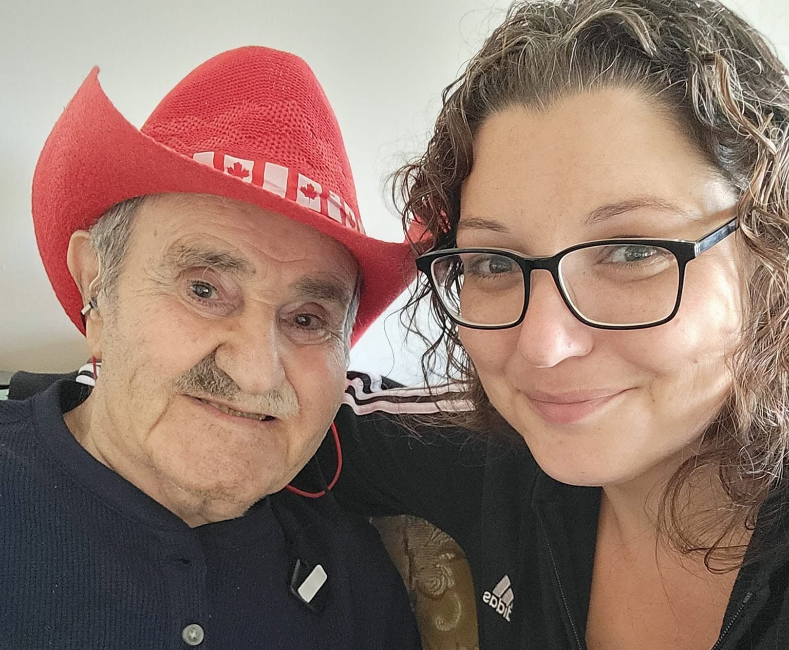 An old man poses with his daughter.