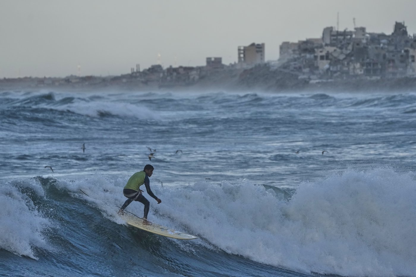 Photos show surfers riding waves along Gaza City’s damaged coastline | iNFOnews.ca