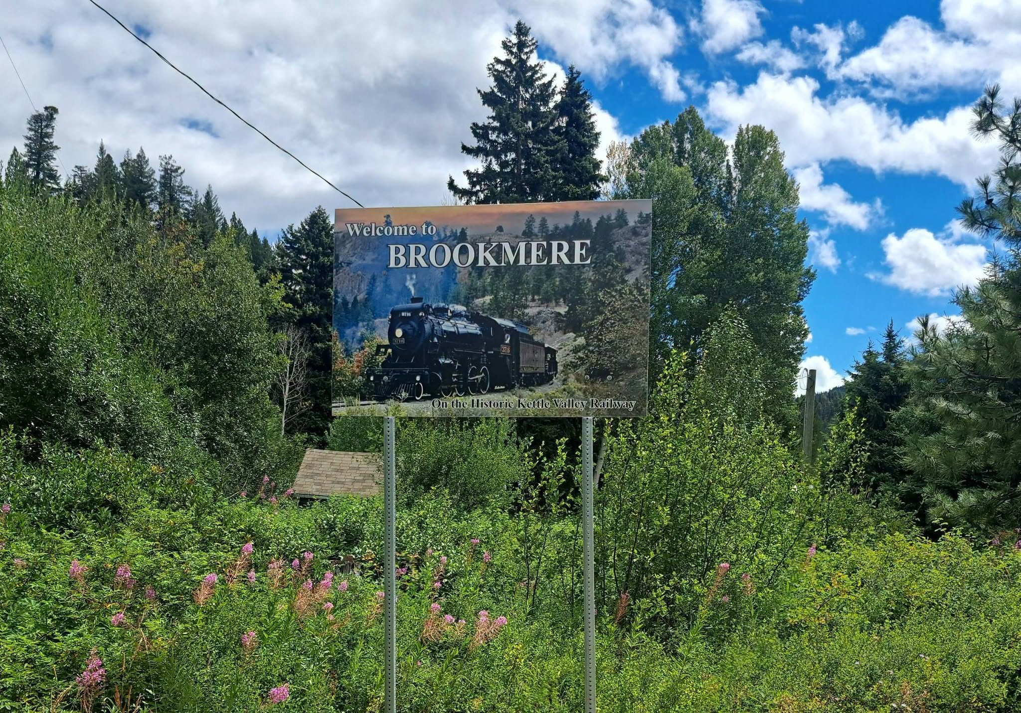 A wooden sign says Welcome to Brookmere on it.
