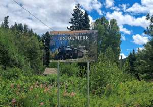 A wooden sign says Welcome to Brookmere on it.