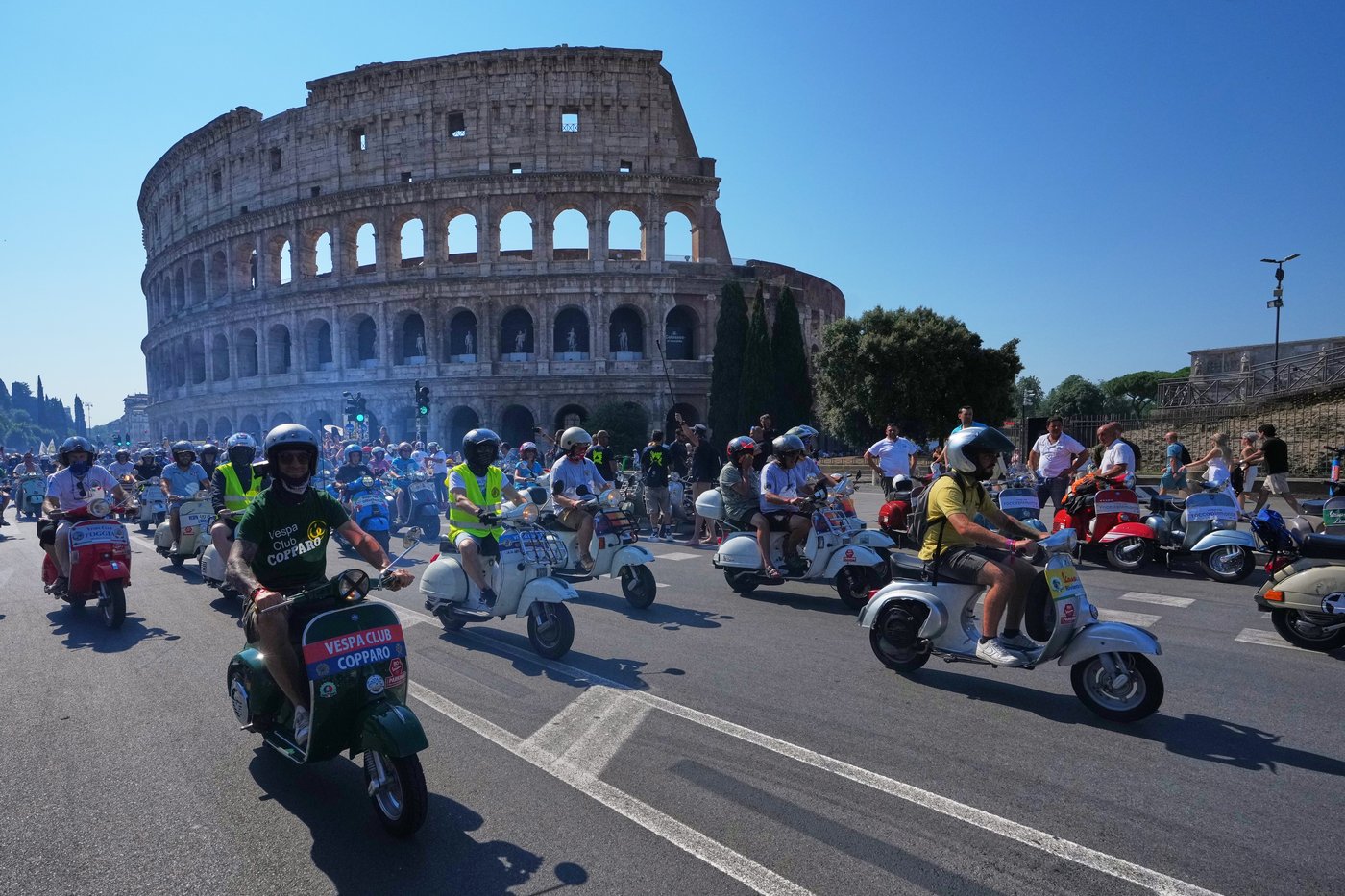 Photos show Vespa enthusiasts buzzing through Rome celebrating the little scooter's 80th anniversary | iNFOnews.ca