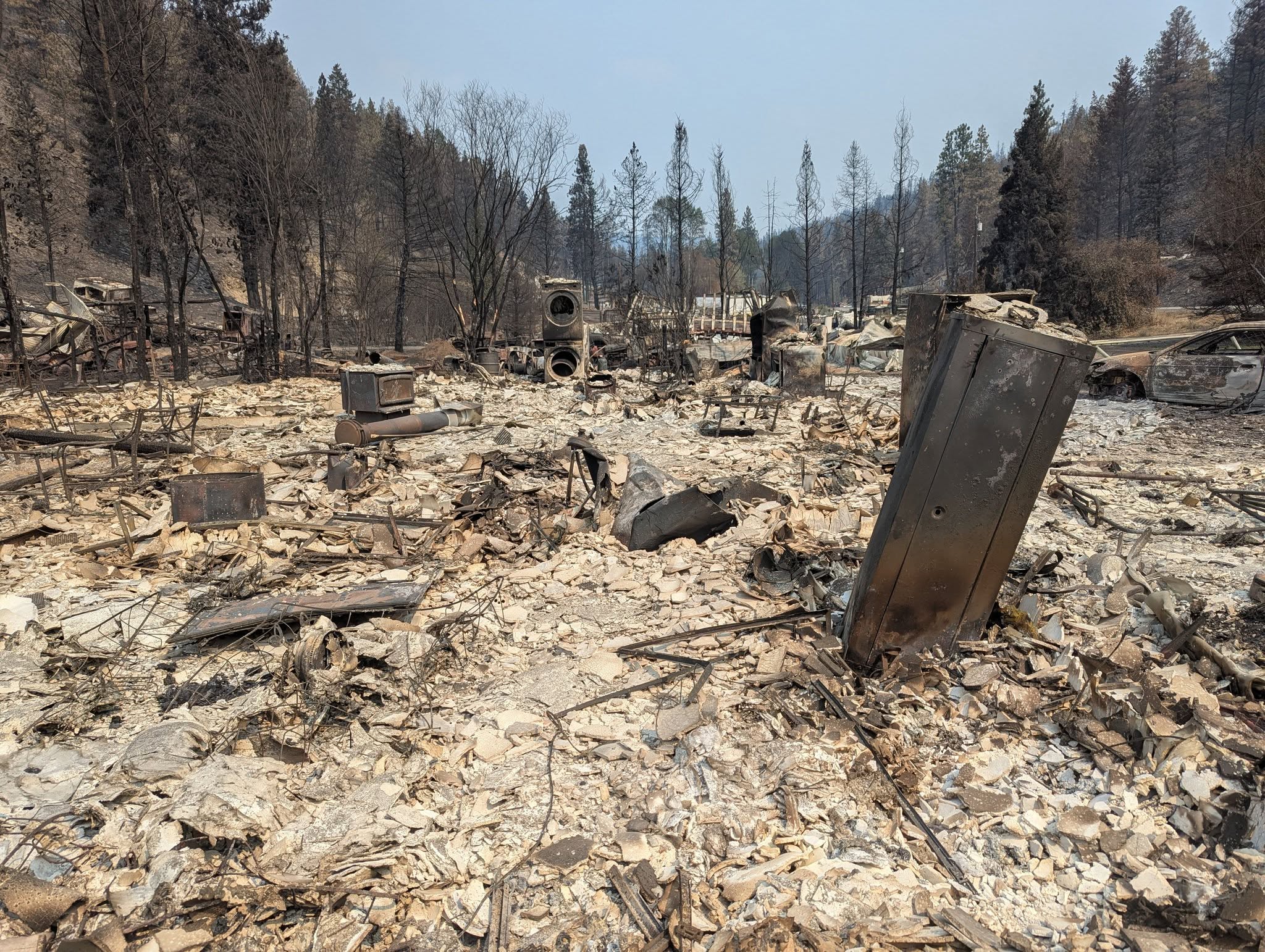 Ash and rubble are left after a wildfire destroyed a house.