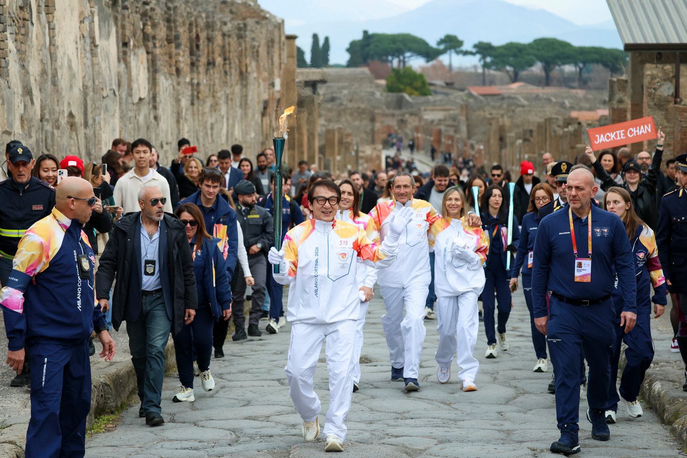 Jackie Chan carries the Milan Cortina Olympic torch through the ruins of Pompeii | iNFOnews.ca