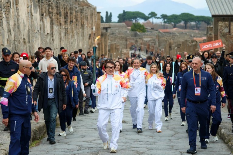 Jackie Chan carries the Milan Cortina Olympic torch through the ruins of Pompeii | iNFOnews.ca