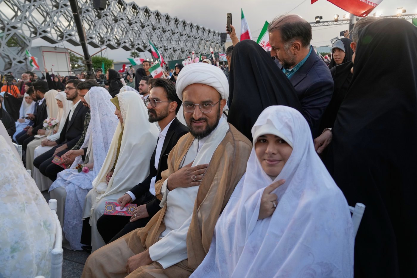Photos of a mass wedding and a colorful missile at Tehran's 'Sacrifice for Iran' ceremony | iNFOnews.ca