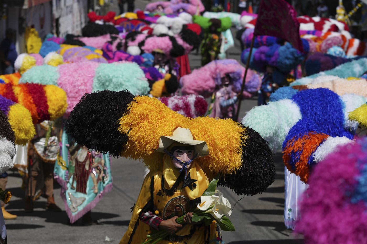 Easter is celebrated with giant caterpillar-like hats and flames in this Mexican town | iNFOnews.ca