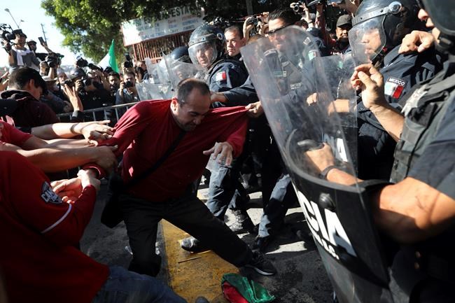 Tijuana protesters chant 'Out!' at migrants camped in city | iNFOnews.ca