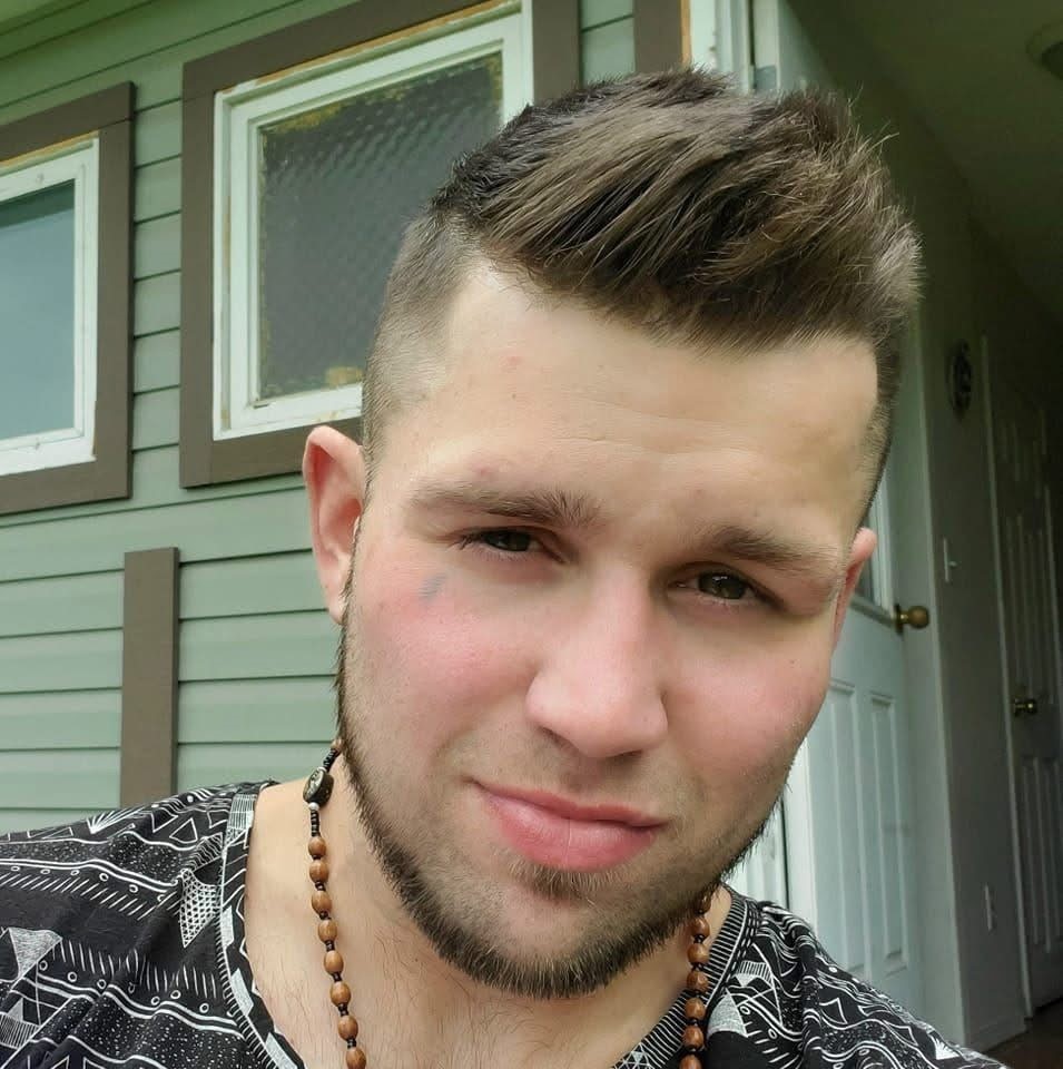 A young man poses for a photo.